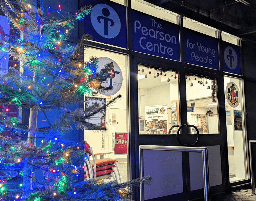 Image shows the entrance of the Pearson Centre with a lit Christmas tree